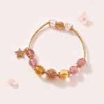 Vòng tay phong thuỷ An gem đá Dâu tây hồng mix TA vàng phối charm
